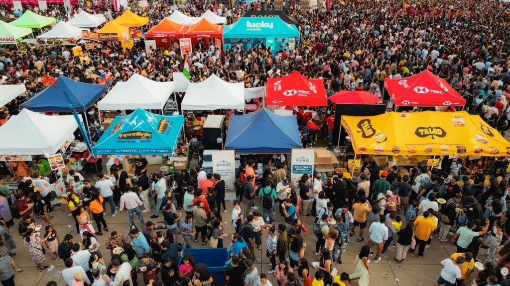 High-traffic retail experiential marketing activation at a Canadian street festival, featuring branded vendor booths, retail product sampling, and dense consumer foot traffic.
