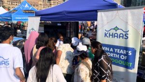 Crowd gathered at Khaas product sampling booth during experiential marketing event with live brand activation and customer engagement