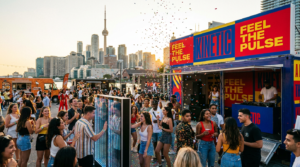 Experiential marketing activation in Toronto with branded pop-up booth, DJ, interactive installation, and crowd engagement against CN Tower skyline.